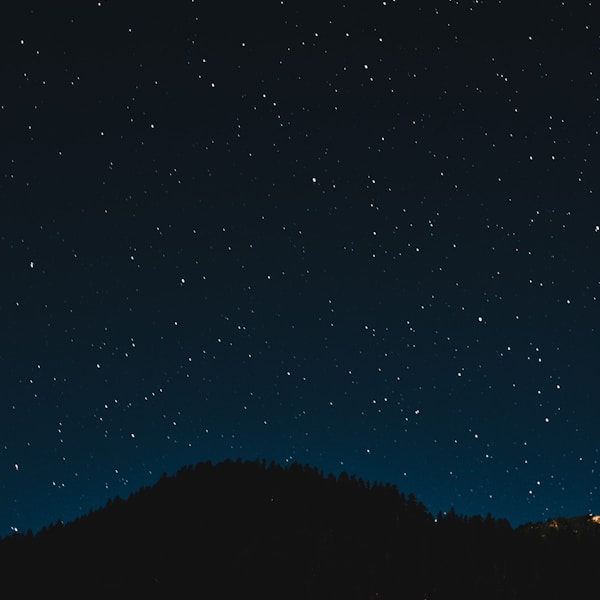 Tropical ocean waves crashing on rocks at sunset